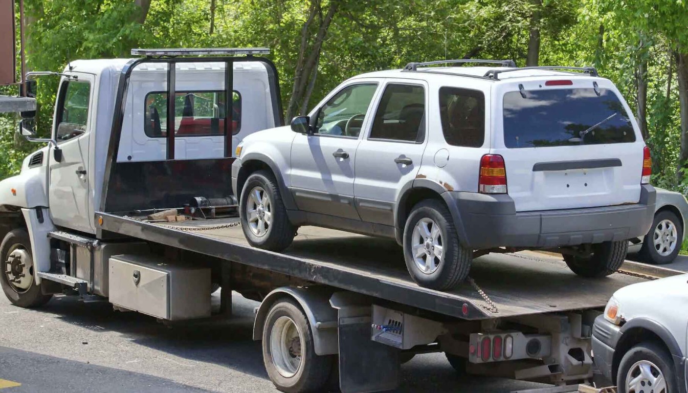 Flatbed towing service transporting vehicle in Rosemead, CA